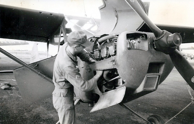 Joe Kemper replacing a spark plug on a 1st Platoon aircraft, 57-8223, while at Hue