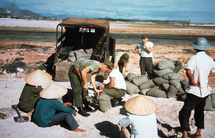 Dennis Currie photo: Sand bags need filling, 1966