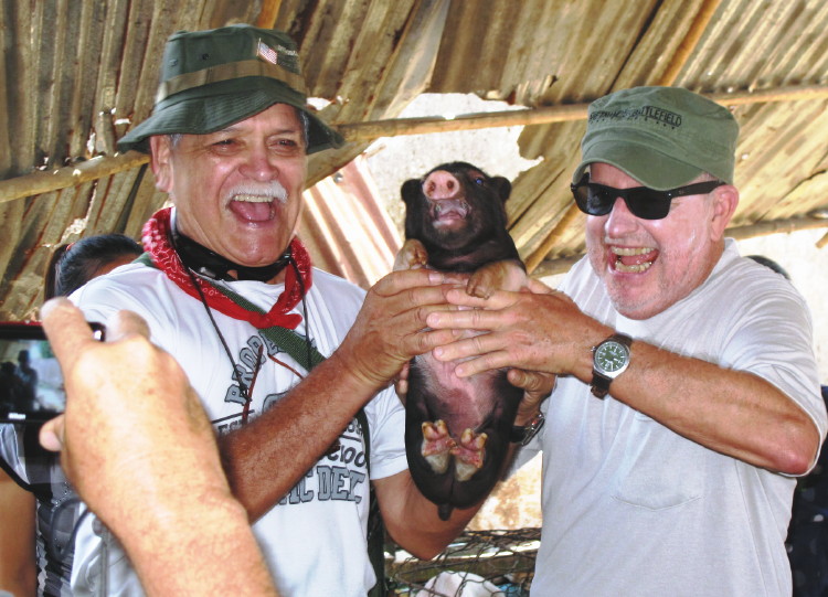 Vietnam Battlefield Tours, visit to Bru Montagnard Village with a basket of five young pigs purchased at a local market